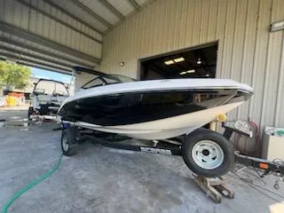 Slide: The Image of 2017 Scarab 195 boat on a trailer in a storage facility. - 14