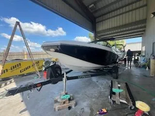 Slide: The Image of 2017 Scarab 195 boat on a trailer in a covered storage area. - 15
