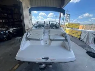 Slide: The Image of 2017 Scarab 195 boat with white seating and canopy in a storage area. - 9