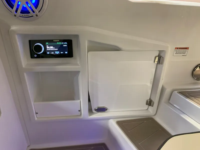 Slide: The Image of 2023 Monterey 298 Super Sport boat interior with control panel and storage compartments. - 10