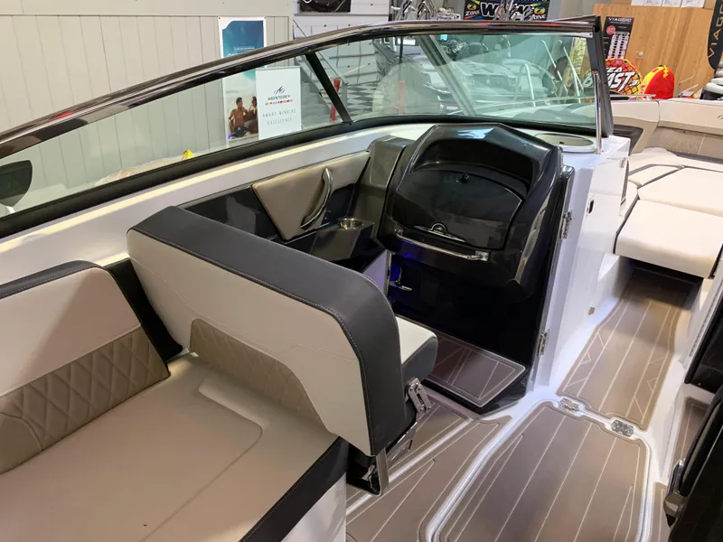 Slide: The Image of 2023 Monterey 298 Super Sport boat interior with modern seating and dashboard. - 13