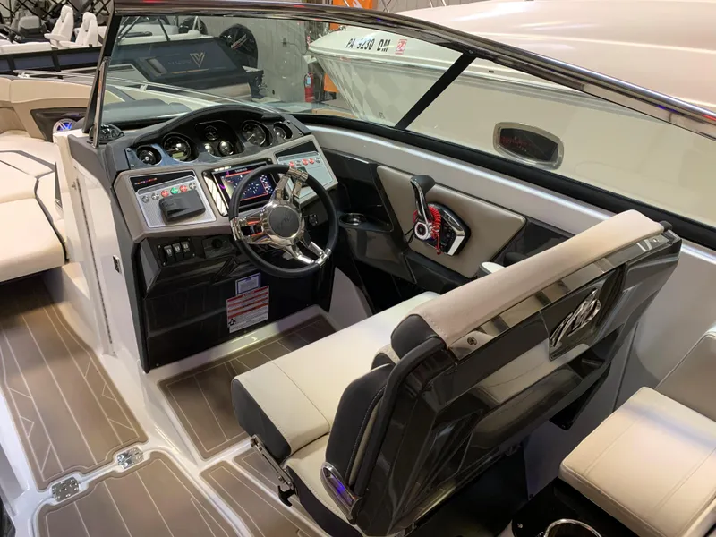 Slide: The Image of 2023 Monterey 298 Super Sport boat interior with modern dashboard and seating. - 14