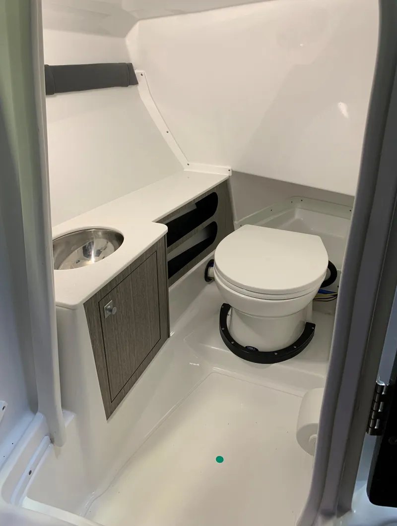 Slide: The Image of 2023 Monterey 298 Super Sport boat bathroom with toilet and sink. - 17
