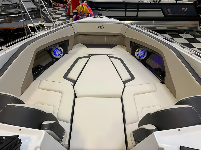 Slide: The Image of 2023 Monterey 298 Super Sport boat interior with cushioned seating and blue LED speakers. - 20