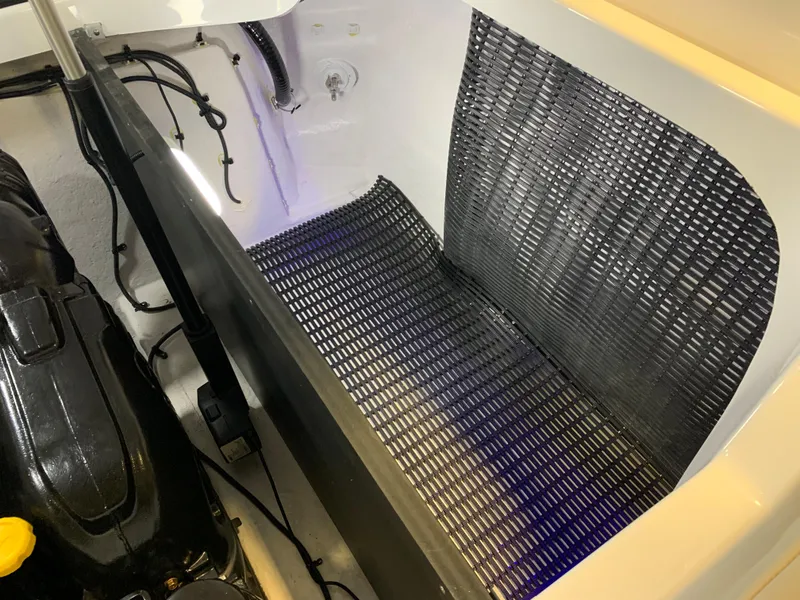 Slide: The Image of 2023 Monterey 298 Super Sport engine compartment with black mat and wiring. - 27