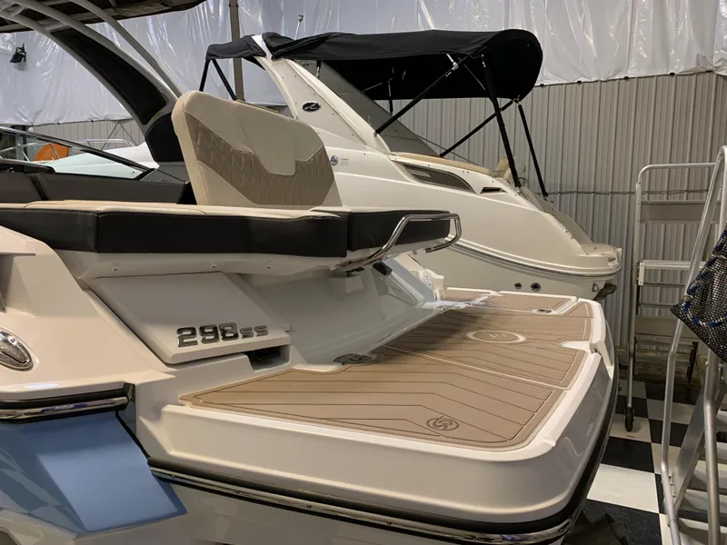 Slide: The Image of 2023 Monterey 298 Super Sport boat in a showroom, rear view. - 4