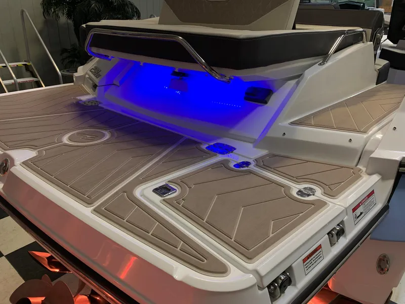 Slide: The Image of 2023 Monterey 298 Super Sport boat with illuminated deck and seating area. - 7