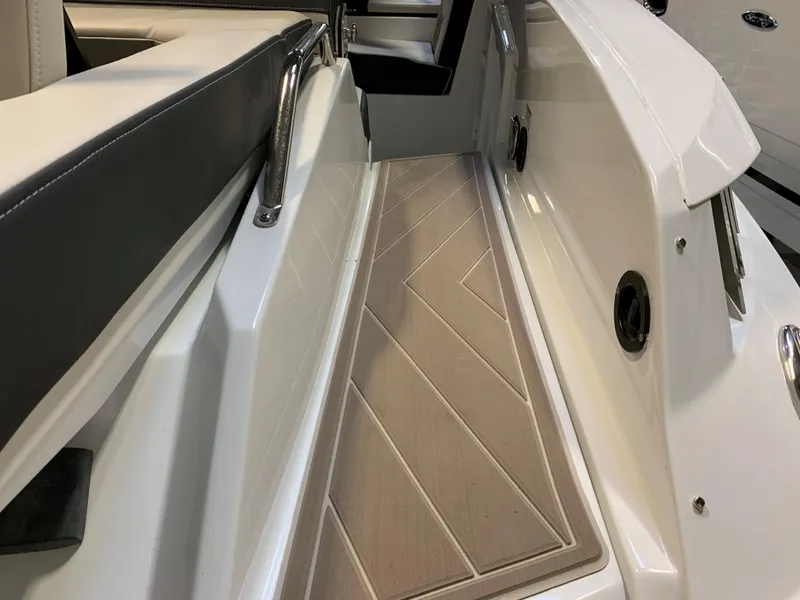 Slide: The Image of 2023 Monterey 298 Super Sport boat interior with cushioned seating and non-slip flooring. - 8