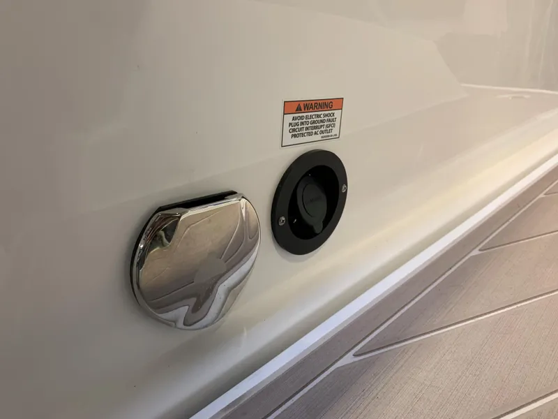 Slide: The Image of 2023 Monterey 298 Super Sport boat detail with warning label and fittings. - 9