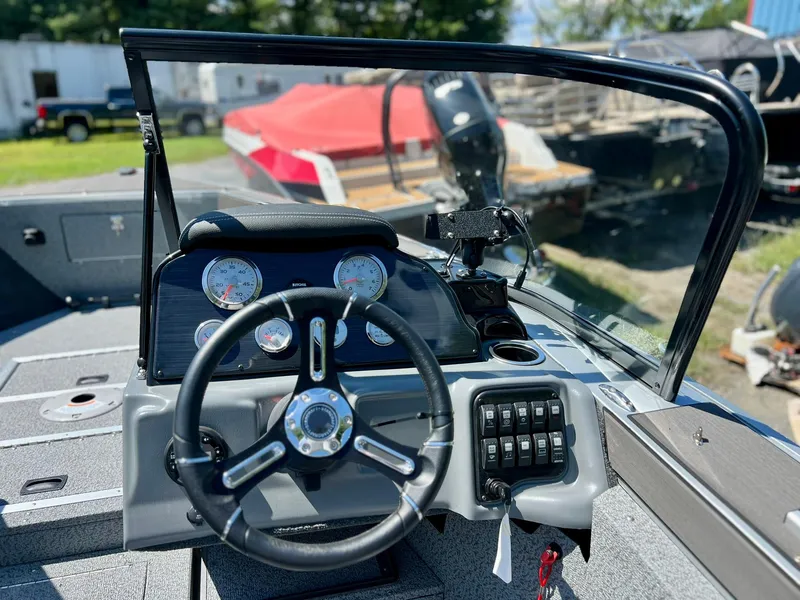 Slide: The Image of 2023 Starcraft Fishmaster 210 boat dashboard with steering wheel and gauges. - 10