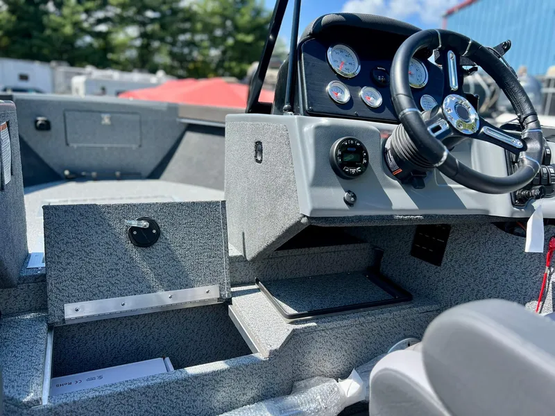 Slide: The Image of 2023 Starcraft Fishmaster 210 boat interior with steering wheel and dashboard controls. - 12