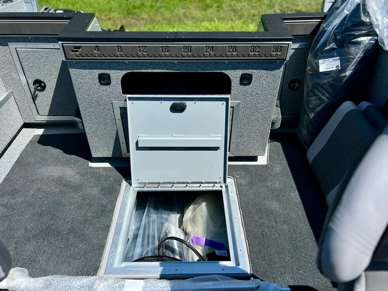 Slide: The Image of 2023 Starcraft Fishmaster 210 boat interior with storage compartment open. - 14