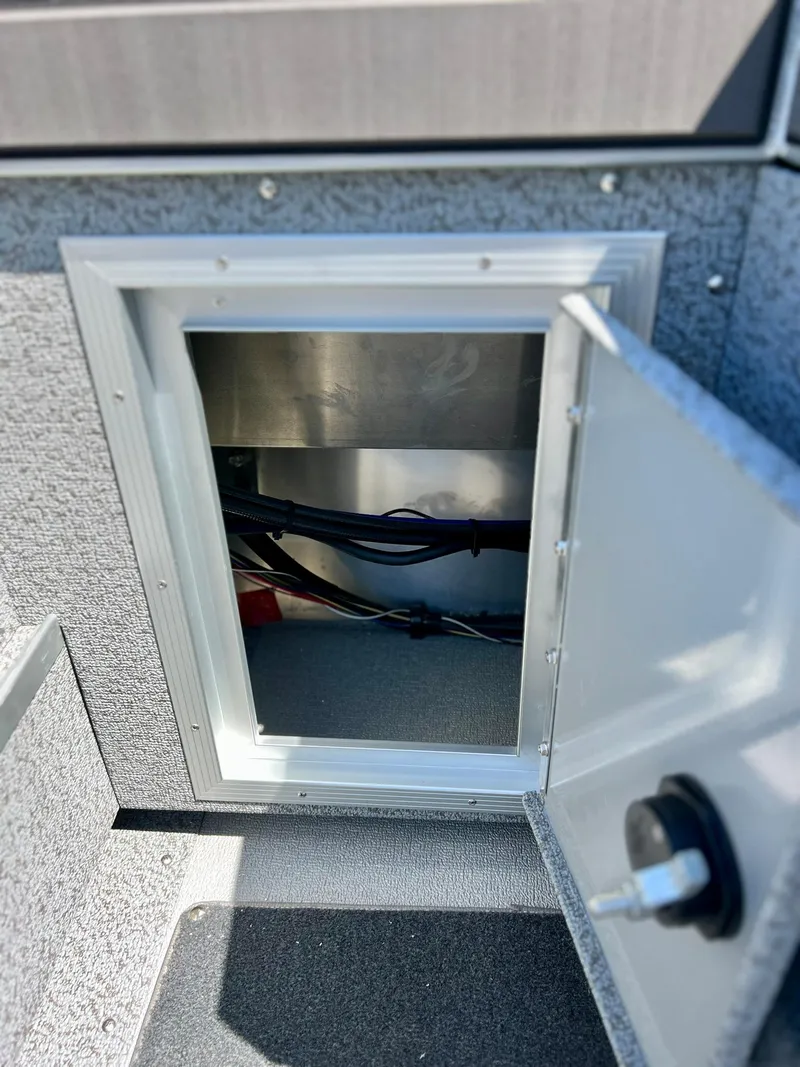 Slide: The Image of Starcraft Fishmaster 210 storage compartment, open door, 2023 model. - 15