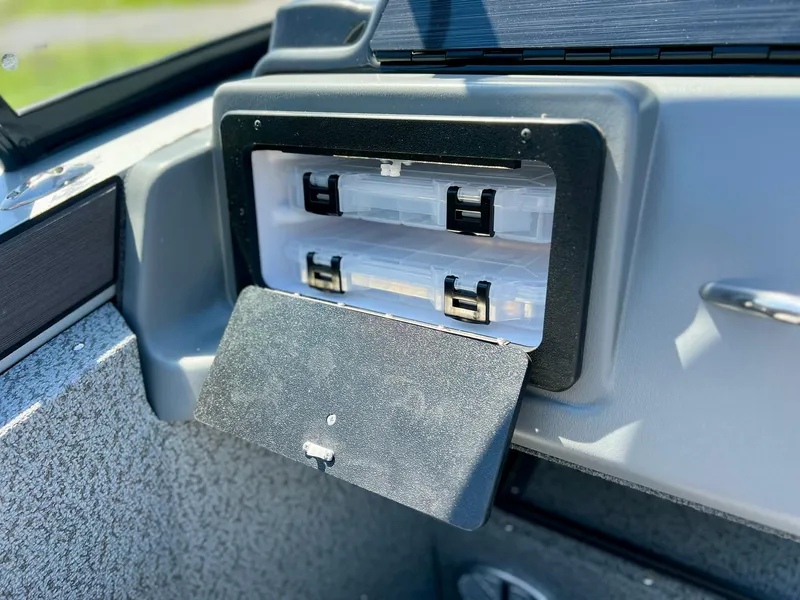 Slide: The Image of Starcraft Fishmaster 210 storage compartment, 2023 model, with open hatch and organized interior. - 19