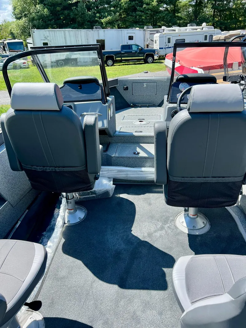 Slide: The Image of Interior of 2023 Starcraft Fishmaster 210 boat with seating and dashboard. - 20