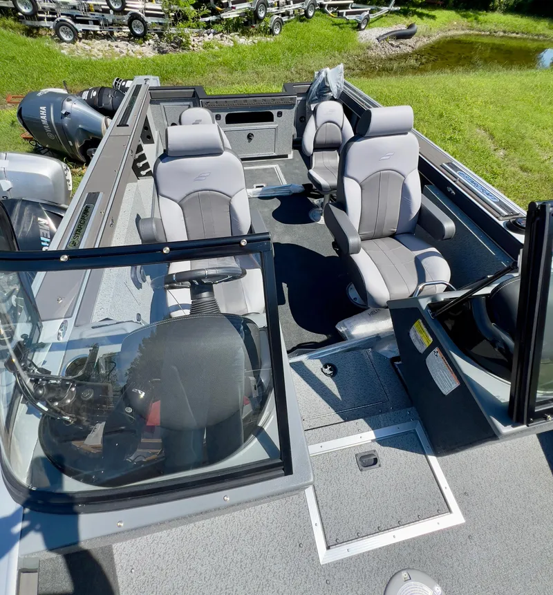 Slide: The Image of 2023 Starcraft Fishmaster 210 boat interior with seating and steering console. - 21