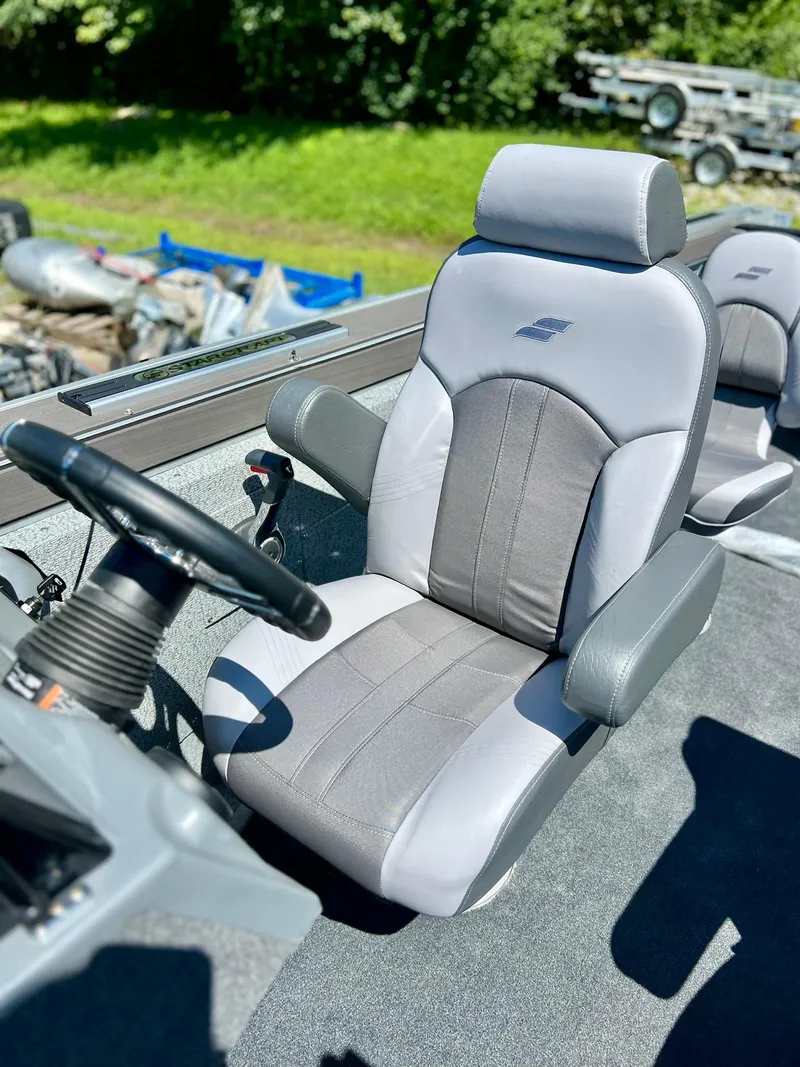 Slide: The Image of 2023 Starcraft Fishmaster 210 boat interior with steering wheel and comfortable seating. - 4