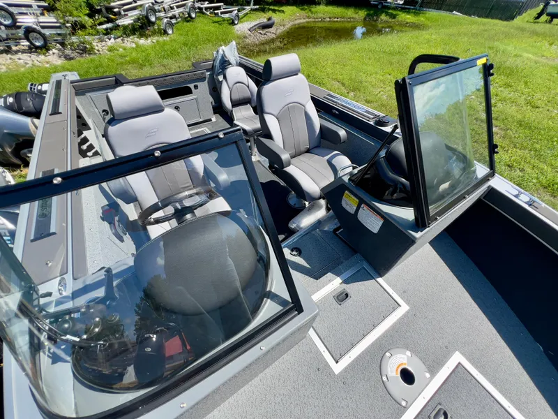 Slide: The Image of 2023 Starcraft Fishmaster 210 boat interior with seating and steering console. - 5