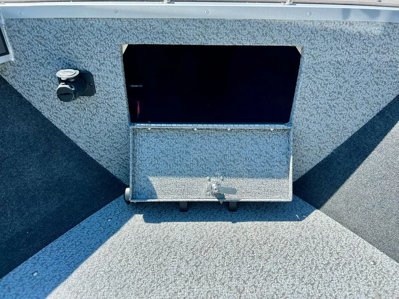 Slide: The Image of 2023 Starcraft Fishmaster 210 boat interior with open storage compartment. - 6