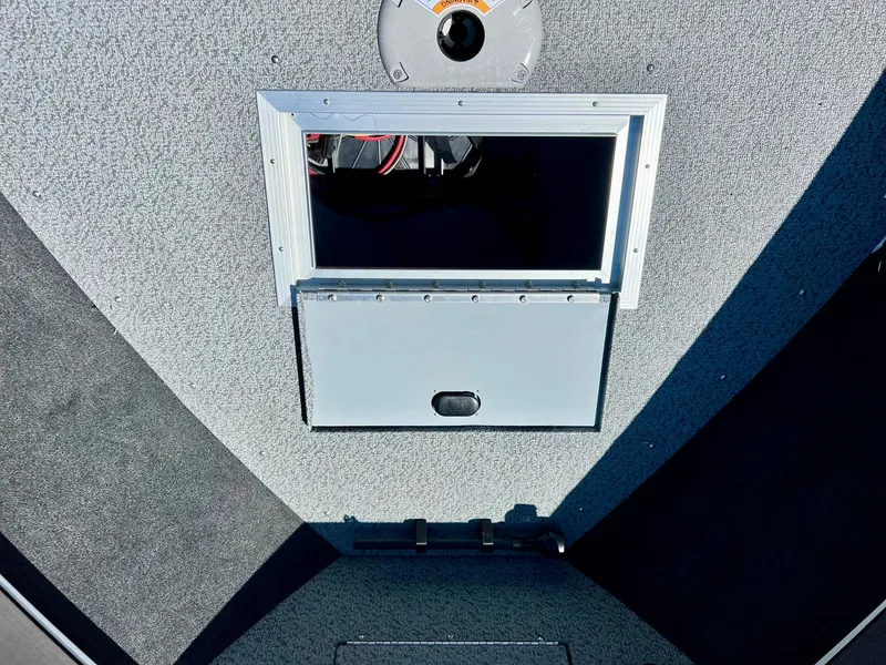 Slide: The Image of 2023 Starcraft Fishmaster 210 boat storage compartment with open hatch. - 7