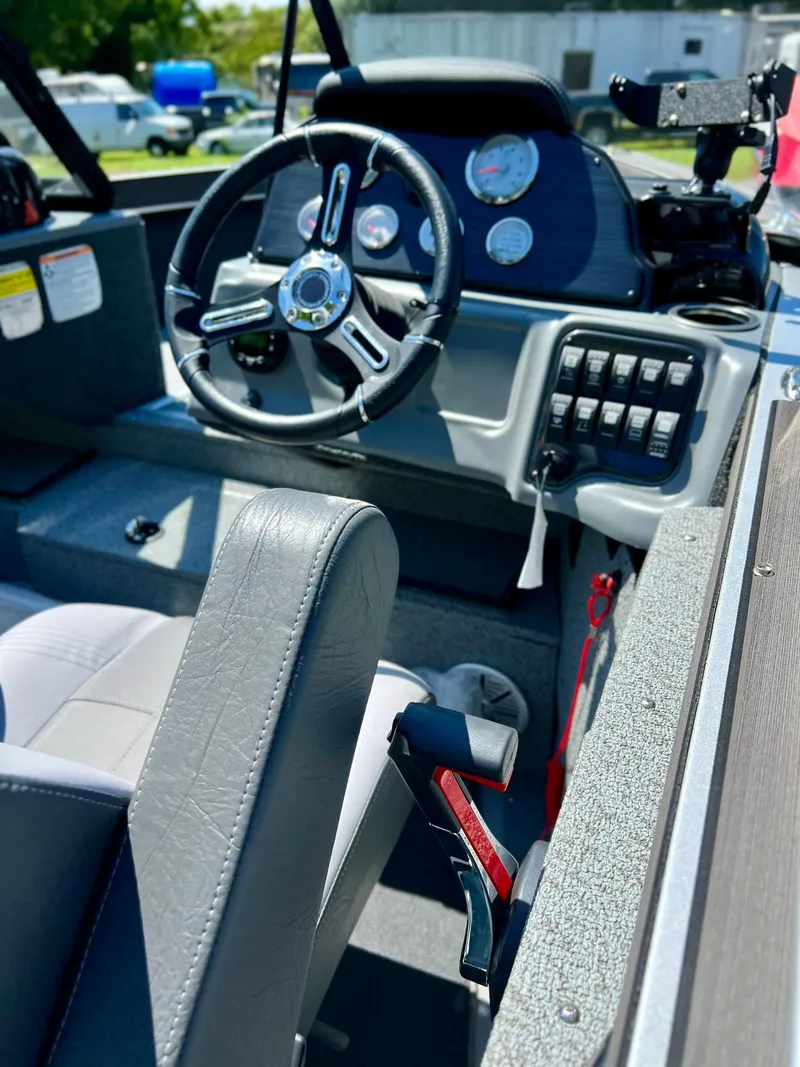 Slide: The Image of 2023 Starcraft Fishmaster 210 boat interior with steering wheel and control panel. - 9