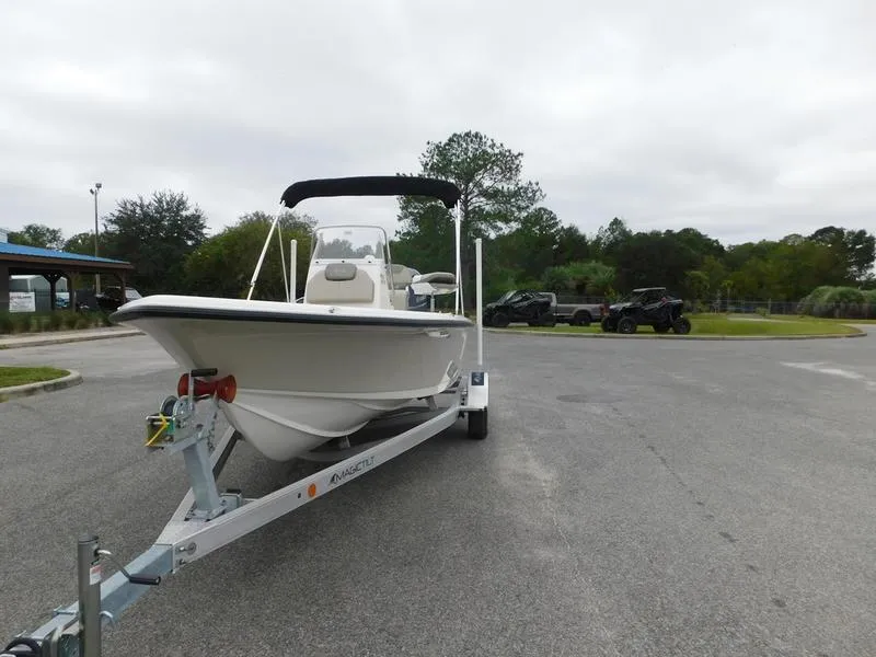 Slide: The Image of 2023 Key West 188 BR boat on a trailer in a parking lot. - 2