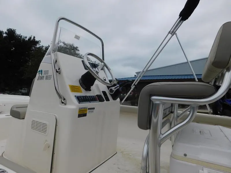 Slide: The Image of 2023 Key West 188 BR boat console and seating area. - 5