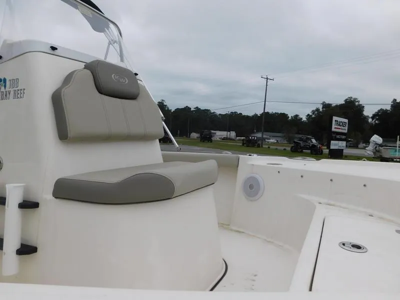 Slide: The Image of 2023 Key West 188 BR boat interior with cushioned seating and storage compartments. - 6