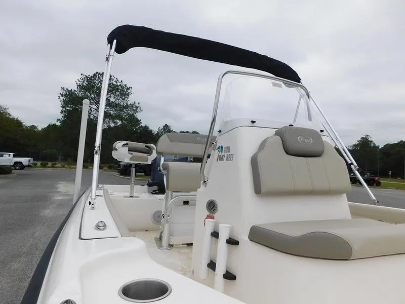 Slide: The Image of 2023 Key West 188 BR boat with seating and canopy, parked outdoors. - 7