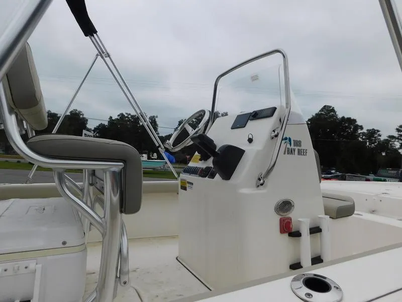 Slide: The Image of 2023 Key West 188 BR boat interior with steering console and seating. - 8