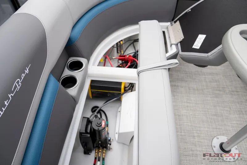 Slide: The Image of 2023 South Bay RearSeating 200hp boat interior showing storage compartment and cup holders. - 10