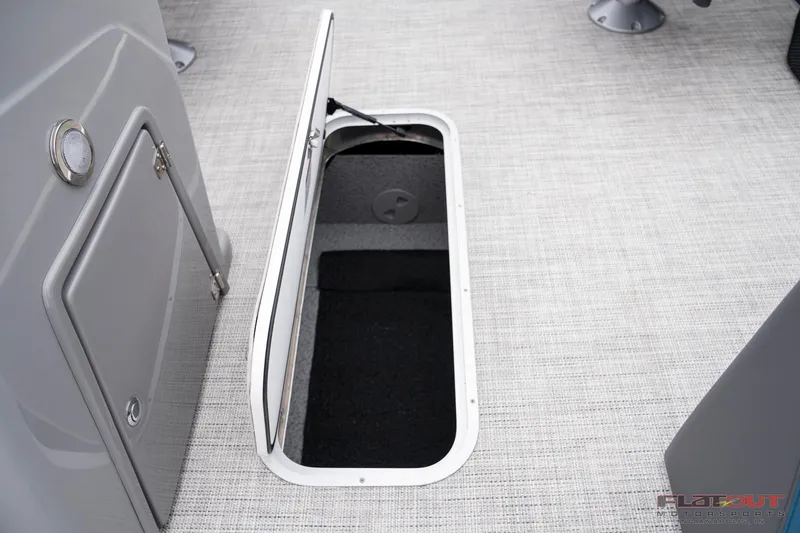 Slide: The Image of 2023 South Bay RearSeating 200hp boat with open storage compartment. - 11