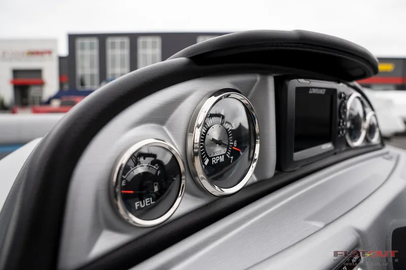 Slide: The Image of Close-up of 2023 South Bay RearSeating 200hp boat dashboard with fuel and RPM gauges. - 16