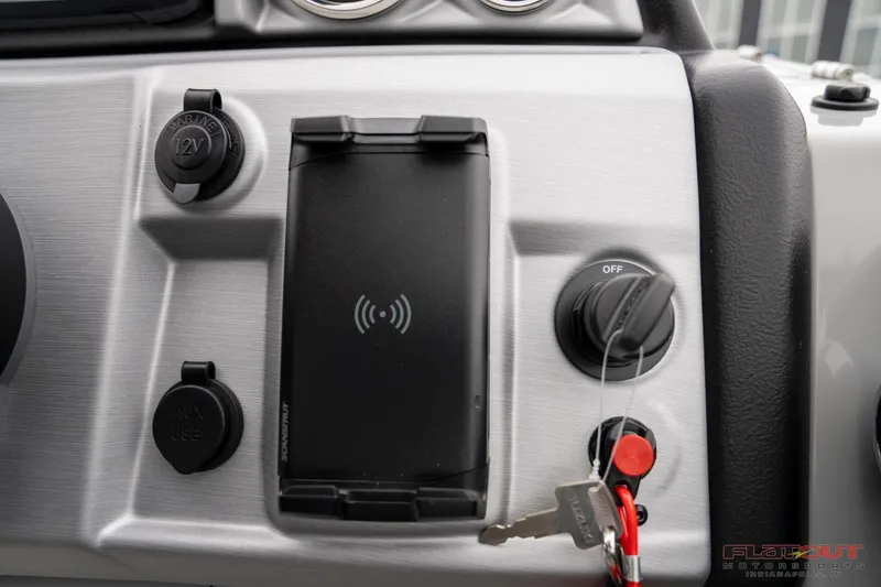 Slide: The Image of Control panel of 2023 South Bay RearSeating 200hp boat with key ignition and charging ports. - 17