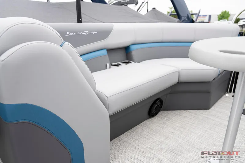 Slide: The Image of 2023 South Bay RearSeating 200hp boat with luxurious gray and blue upholstery. - 2
