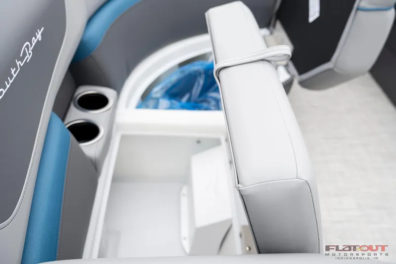 Slide: The Image of 2023 South Bay RearSeating 200hp boat interior with storage compartment and cup holders. - 23