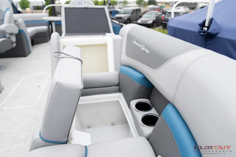 Slide: The Image of 2023 South Bay RearSeating 200hp boat interior with storage and cup holders. - 26