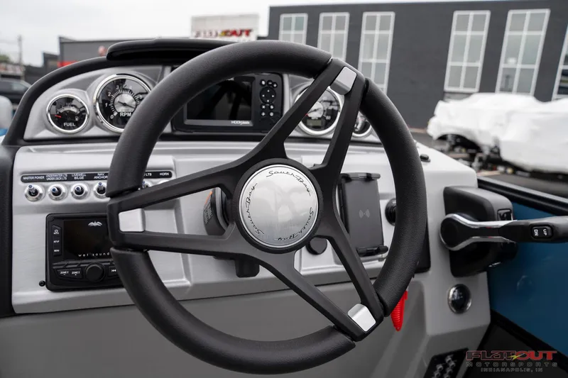 Slide: The Image of 2023 South Bay RearSeating 200hp boat steering wheel and dashboard controls. - 29