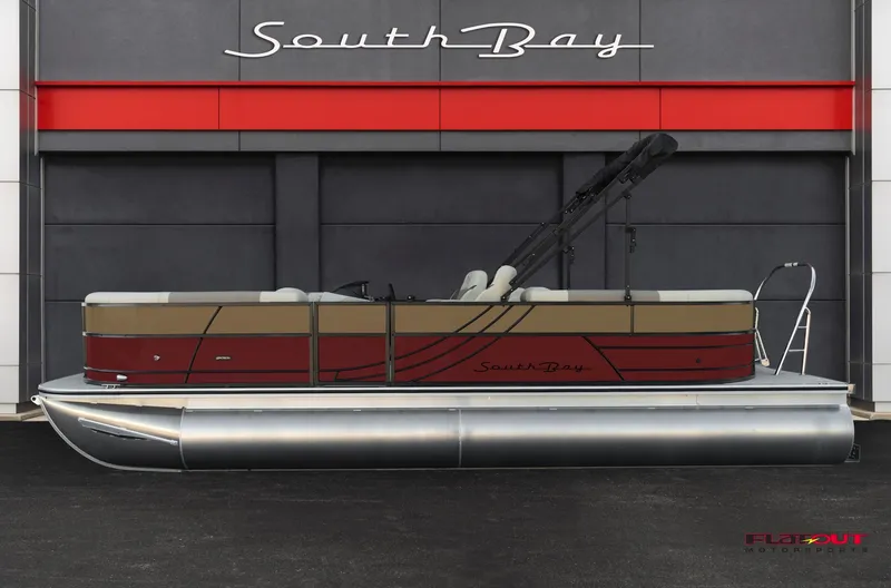 Slide: The Image of 2023 South Bay RearSeating 200hp pontoon boat in front of dealership. - 0