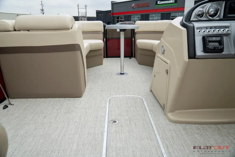 Slide: The Image of 2023 South Bay RearSeating 200hp boat interior with beige seating and modern dashboard. - 11