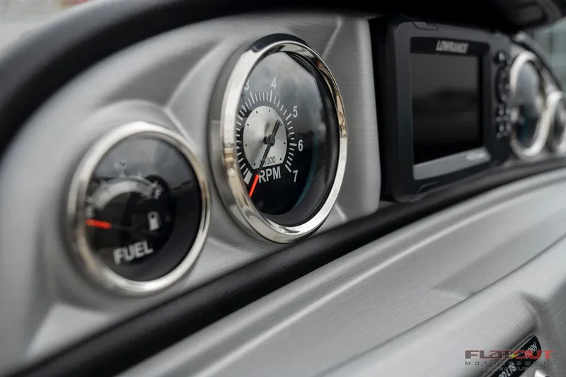 Slide: The Image of Close-up of 2023 South Bay RearSeating 200hp boat dashboard with fuel and RPM gauges. - 12