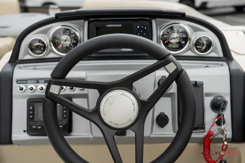 Slide: The Image of 2023 South Bay RearSeating 200hp boat dashboard with steering wheel and control panel. - 16