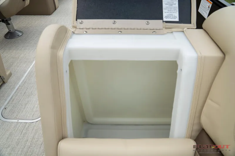 Slide: The Image of 2023 South Bay RearSeating 200hp boat storage compartment with beige upholstery. - 26
