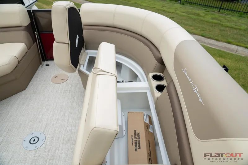 Slide: The Image of 2023 South Bay RearSeating 200hp boat interior with storage compartments and beige seating. - 7