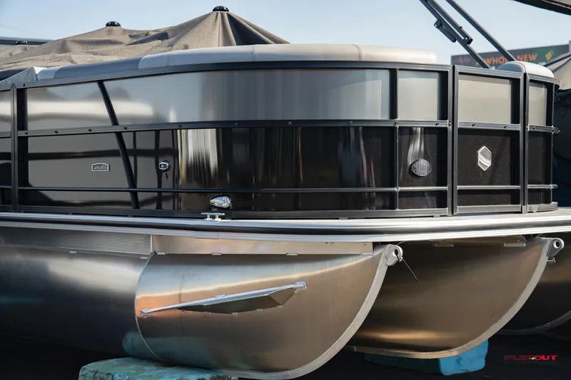 Slide: The Image of 2023 South Bay RearSeating 200hp pontoon boat, front view, docked. - 1