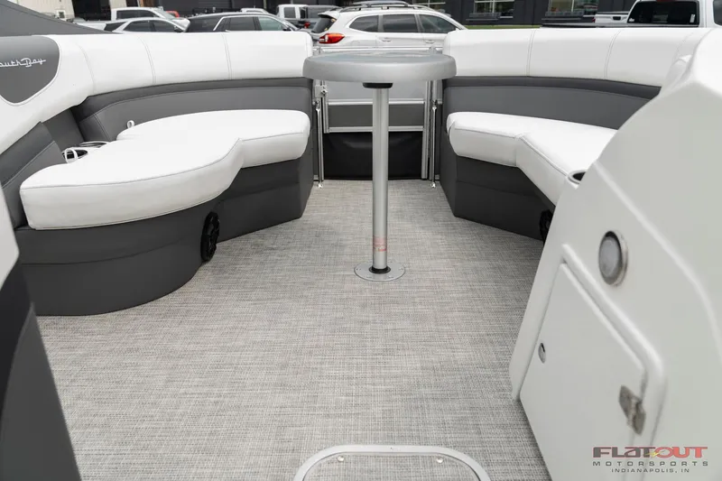 Slide: The Image of 2023 South Bay S224 Cruise & Fish 200HP boat interior with cushioned seating and table. - 2