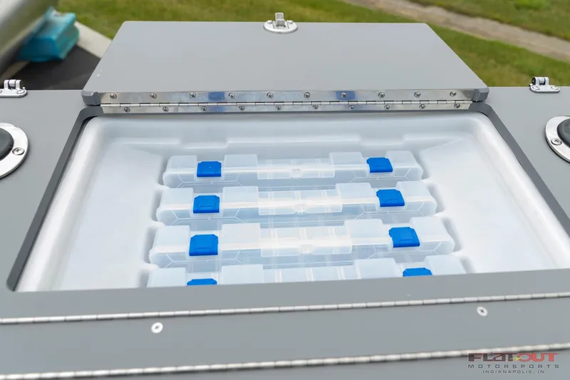 Slide: The Image of 2023 South Bay S224 Cruise & Fish 200HP tackle storage compartment with organized containers. - 27