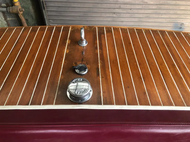 Slide: The Image of 1960 Chris-Craft 24 Sportsman wooden deck with chrome fittings and red leather trim. - 4