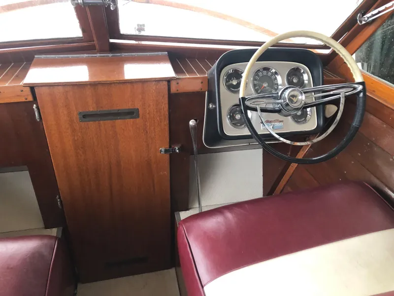 Slide: The Image of 1960 Chris-Craft 24 Sportsman boat interior with wooden dashboard and vintage steering wheel. - 5