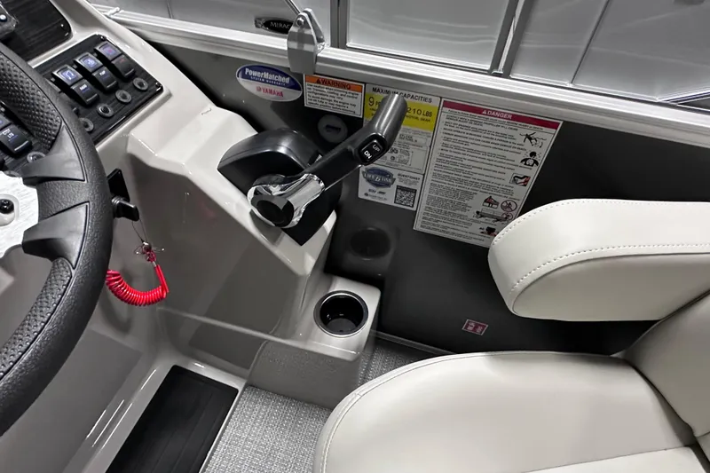 Slide: The Image of Interior of 2026 Sylvan Mirage 820 LZ boat, featuring steering wheel and control panel. - 11